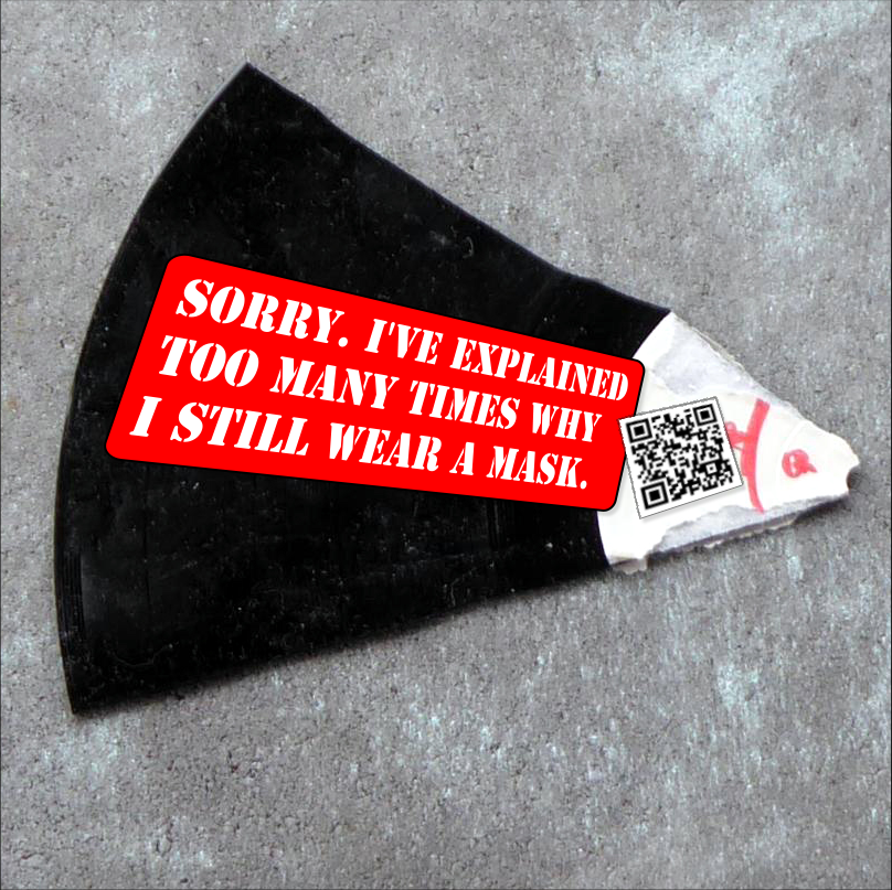 A shard of a record with a sticker on it that reads "Sorry. I've explained too many times why i still wear a mask". Next to it there's a QR-code that leads to our zine: An Open Letter to our Comrades