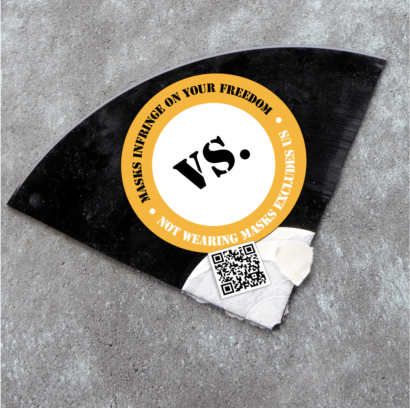A shard of a record with a sticker on it that reads "Masks infringe on your freedom vs. Not wearing masks excludes us". Next to it there's a QR-code that leads to our zine: An Open Letter to our Comrades